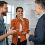 Group of multiracial business people talking, discussion start up project, brainstorming at workplace. Creative colleagues working together in modern office. Teamwork concept
